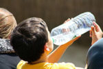 boy drinking from water bottle